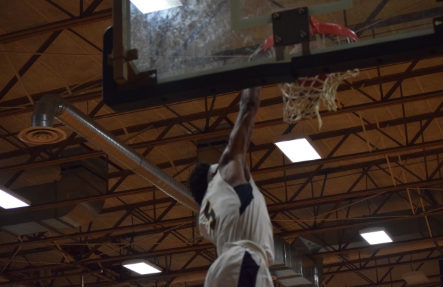 Tez Collins dunks for 2 of his game-high 27 points